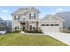 Charming two-story home features a combination of stone and siding with an attached two car garage at 14116 Glaswick Dr, Charlotte, NC 28278