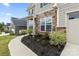 Attractive home exterior featuring stone accents, manicured landscaping, and a paved walkway at 14116 Glaswick Dr, Charlotte, NC 28278