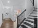 Entryway with hardwood floors, staircase, and view of the home office through French doors at 14116 Glaswick Dr, Charlotte, NC 28278