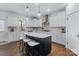 Spacious kitchen featuring a large island, white cabinetry, and stainless steel appliances at 14116 Glaswick Dr, Charlotte, NC 28278