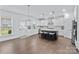 Spacious kitchen features an island with seating, stainless steel appliances, and ample natural light from large windows at 14116 Glaswick Dr, Charlotte, NC 28278