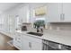 Well-lit kitchen with stainless steel appliances, white cabinets, and stylish backsplash at 14116 Glaswick Dr, Charlotte, NC 28278