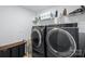 Well-equipped laundry room with modern washer and dryer, plus plenty of storage at 14116 Glaswick Dr, Charlotte, NC 28278