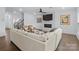 Living room with fireplace, hardwood floors, modern lighting, ceiling fan, and comfortable seating at 14116 Glaswick Dr, Charlotte, NC 28278