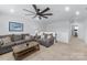 Comfortable living room with modern ceiling fan, neutral-toned walls, and cozy seating area at 14116 Glaswick Dr, Charlotte, NC 28278