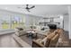 Spacious living room with hardwood floors, fireplace, ceiling fan, and open layout perfect for entertaining at 14116 Glaswick Dr, Charlotte, NC 28278