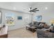 Bright living room features neutral walls, modern ceiling fan and furniture, and natural light from two windows at 14116 Glaswick Dr, Charlotte, NC 28278
