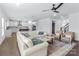 Open-concept living room connects to a modern kitchen, enhanced by hardwood floors and natural light at 14116 Glaswick Dr, Charlotte, NC 28278