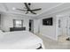 Spacious main bedroom with trey ceiling, ceiling fan, dark dresser and a large window at 14116 Glaswick Dr, Charlotte, NC 28278