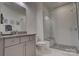 Modern bathroom with a glass-enclosed shower, granite vanity, and neutral color palette at 1427 Main St, Charlotte, NC 28204