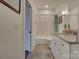 Bright bathroom features tiled shower, white cabinets, gray countertop and wood-style floors at 1427 Main St, Charlotte, NC 28204