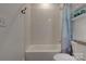 Clean bathroom with a bathtub, white subway tiles, and blue shower curtain at 1427 Main St, Charlotte, NC 28204