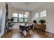 Stylish dining room featuring hardwood floors, a modern chandelier, and large windows with ample natural light at 1427 Main St, Charlotte, NC 28204