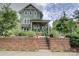 Charming two-story home with a brick facade, covered porch, and beautifully landscaped front yard at 1427 Main St, Charlotte, NC 28204