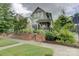 Charming two-story home with a brick facade and beautifully landscaped front yard, situated on a quiet street at 1427 Main St, Charlotte, NC 28204