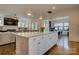 Open-concept kitchen with a large island, granite countertops, and stainless steel appliances flowing into the living area at 1427 Main St, Charlotte, NC 28204