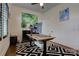 Functional office space with modern decor, a sit-stand desk, and geometric pattern rug at 1427 Main St, Charlotte, NC 28204