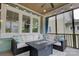 Inviting screened porch with comfortable seating, a ceiling fan, and natural light at 1427 Main St, Charlotte, NC 28204
