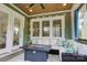 Inviting screened porch with comfortable seating and outdoor fireplace at 1427 Main St, Charlotte, NC 28204