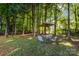 Scenic backyard featuring an outdoor seating area, with lush trees offering a peaceful and private setting at 1445 Deer Forest Dr, Indian Land, SC 29707
