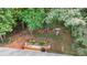 An aerial view of backyard featuring a seating area, built-in bench, landscaping, and mature trees at 1445 Deer Forest Dr, Indian Land, SC 29707
