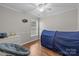 Bedroom with hardwood floors, neutral paint, ceiling fan, and a large window at 1445 Deer Forest Dr, Indian Land, SC 29707
