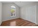 Bright bedroom with hardwood floors, large window, and spacious closet for ample storage at 1445 Deer Forest Dr, Indian Land, SC 29707