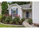 Well-maintained front yard and home with colorful landscaping, blue shutters, and charming curb appeal at 1445 Deer Forest Dr, Indian Land, SC 29707