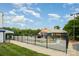 Community pool with a splash pad for surrounded by a black metal fence and lush green grass at 1445 Deer Forest Dr, Indian Land, SC 29707