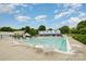 A view of the community pool that includes lounge chairs, tables, umbrellas, and a slide at 1445 Deer Forest Dr, Indian Land, SC 29707