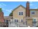 View of the back exterior featuring a deck, siding, and brick chimney at 1670 Robins Nest Ct # C, Gastonia, NC 28054