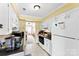 Kitchen features tile floors, white cabinets, and a view into the dining room area at 1670 Robins Nest Ct # C, Gastonia, NC 28054
