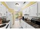 Bright kitchen features white cabinets, tile floors and a view into the breakfast nook at 1670 Robins Nest Ct # C, Gastonia, NC 28054