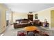 Cozy living room with a brown sofa, ceiling fan, and a glimpse of the sliding back door at 1670 Robins Nest Ct # C, Gastonia, NC 28054