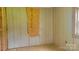 Unfinished bedroom showing wood-paneled walls, wood laminate flooring, and exposed plywood at 1672 Riverview Rd, Lincolnton, NC 28092