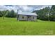 Charming single story home with a metal roof and chimneys on either side on a large lot at 1672 Riverview Rd, Lincolnton, NC 28092