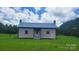 Charming single story home on a large lot with a metal roof and chimneys on either side at 1672 Riverview Rd, Lincolnton, NC 28092