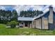 View of the house and deck, set on a grassy lot in a neighborhood at 1672 Riverview Rd, Lincolnton, NC 28092