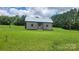 Charming single story home with a metal roof and chimneys on either side in a grassy lot at 1672 Riverview Rd, Lincolnton, NC 28092