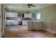 View of the kitchen featuring wood floors, natural light, and dated appliances at 1672 Riverview Rd, Lincolnton, NC 28092
