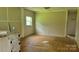 Living room in need of repair with hardwood floors and natural light at 1672 Riverview Rd, Lincolnton, NC 28092