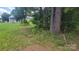 The property features a wooded lot with a charming cottage and lots of trees at 1672 Riverview Rd, Lincolnton, NC 28092