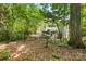 Fenced backyard showcases a peaceful setting with views of the home's rear exterior and mature trees at 171 Highland Woods Ct, Denver, NC 28037