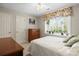 Cozy bedroom with natural light, a comfortable bed, and a peaceful ambiance, great for relaxation at 171 Highland Woods Ct, Denver, NC 28037