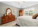 Bright bedroom with a queen bed, dresser, armoire, and sunny windows at 171 Highland Woods Ct, Denver, NC 28037