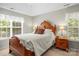 Bedroom with a large bed, two windows, and wood furniture at 171 Highland Woods Ct, Denver, NC 28037