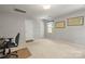 Neutral bedroom with two doors, office setup, and two decorative wall maps at 171 Highland Woods Ct, Denver, NC 28037