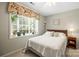 Comfortable bedroom featuring natural light, neutral decor, and a serene atmosphere, ideal for restful nights at 171 Highland Woods Ct, Denver, NC 28037