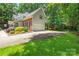 Two-story brick home with a two-car garage and driveway, framed by lush landscaping at 171 Highland Woods Ct, Denver, NC 28037