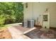 Rear view of the home with a brick-paver patio and a small landscaped area at 171 Highland Woods Ct, Denver, NC 28037